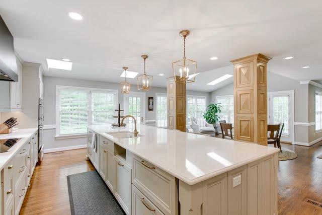 A stylish kitchen showcasing a center island and warm hardwood floors