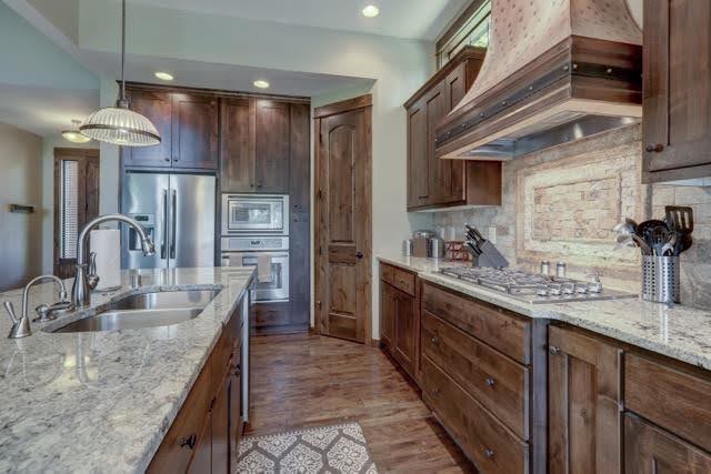 A stylish kitchen with rich wood cabinetry and sleek granite countertops