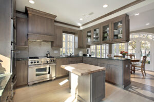 A kitchen featuring a stove and a dining table, showcasing a functional and inviting cooking space.