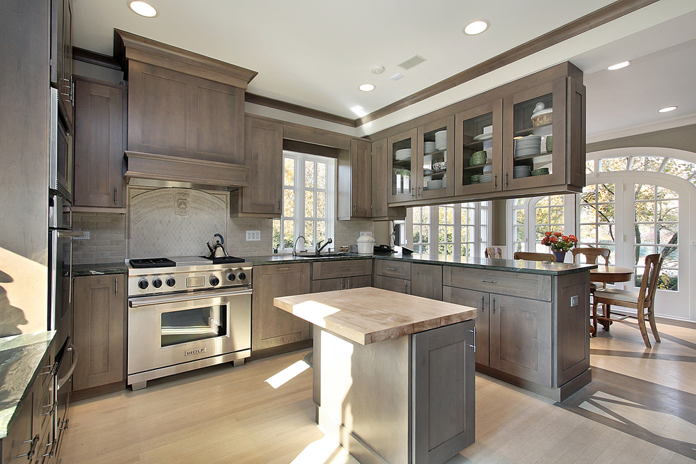 A kitchen featuring a stove and a dining table, showcasing a functional and inviting cooking space.