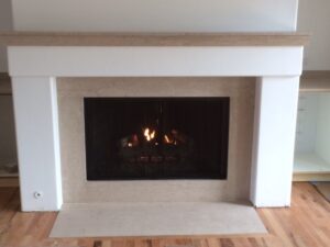 An inviting fireplace with a mantle and shelf, ideal for adding a touch of charm and warmth to any room.