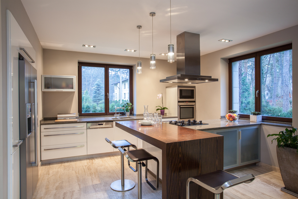 Modern kitchen featuring a center island and stylish bar stools.