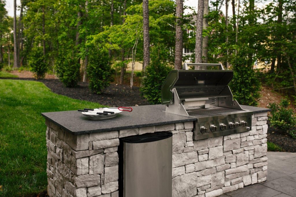 An outdoor kitchen made of stone showcasing a grill on top ideal for outdoor cooking and gatherings
